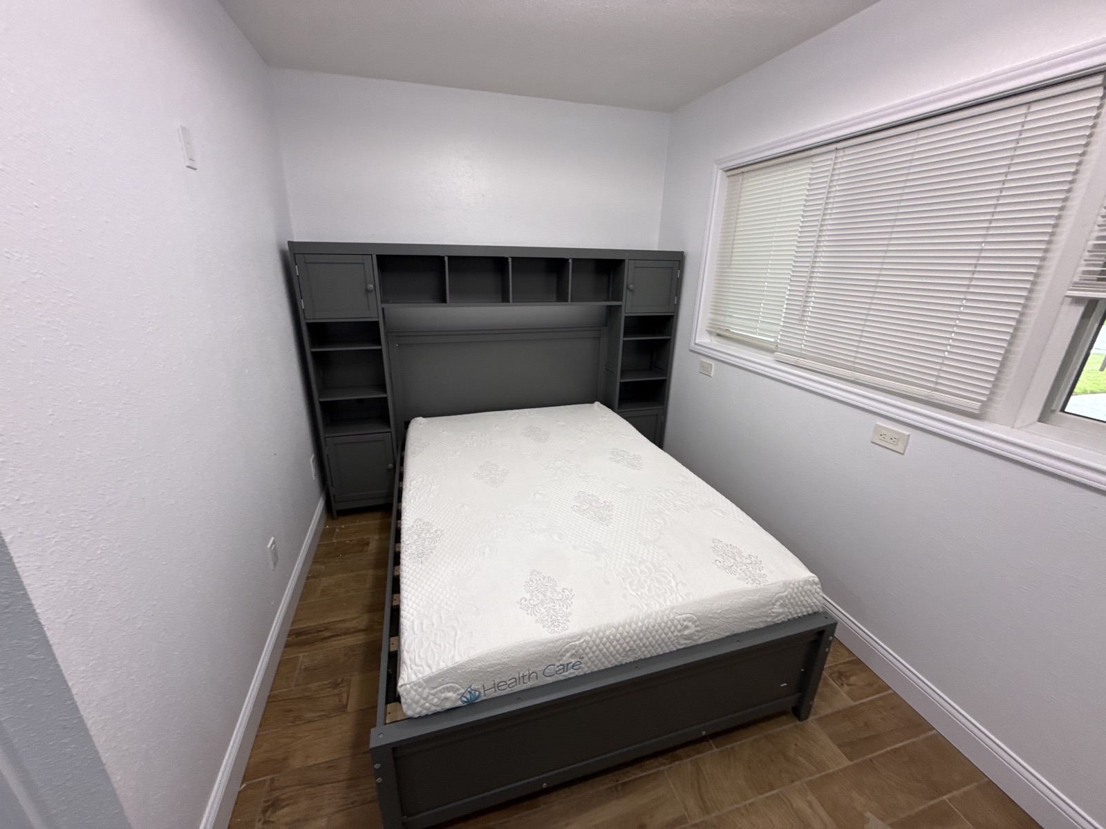 Assembled bed frame with built-in headboard storage