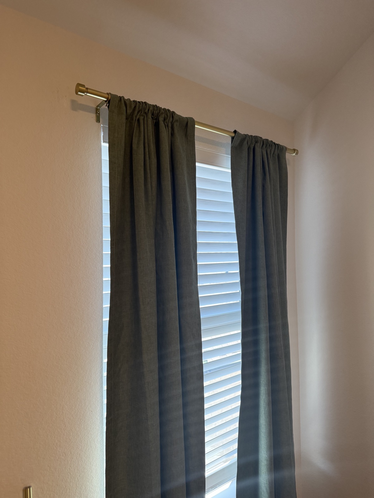Curtain rod installed straight above a bedroom window